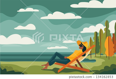 A person relaxes in a chair by the beach on a sunny day. They enjoy the view of the ocean and the clouds above. Trees line the background, adding to the scene A person relaxes in a chair by the beach on a sunny day. They enjoy the view of the ocean and the clouds above. Trees line the background, adding to the scene 134162853