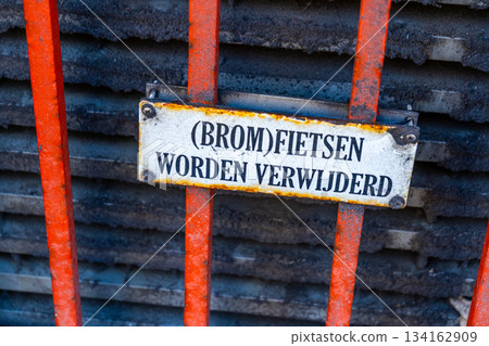 Dutch language Warning sign Mopeds will be removed - translation. Bicycle parking prohibited. Old metal sign. Amsterdam street Netherlands 134162909