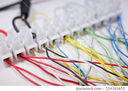 Colorful electrical wiring connected to terminal strip 134163655