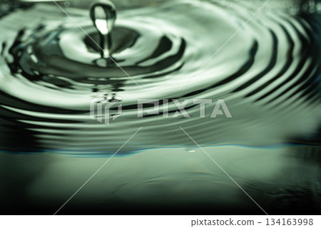242.Green-Tinted Ripples and Droplet on Water Surface 134163998