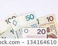 Collection of Polish banknotes of different denominations on a light background 134164610