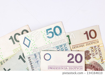 Collection of Polish banknotes of different denominations on a light background 134164610