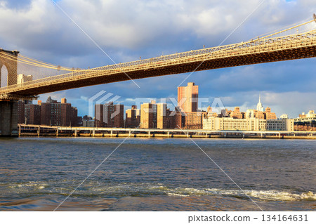 View of Brooklyn Bridge with NY city skyline water during daytime in New York City 134164631