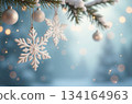 Christmas snowflakes hanging on snowy fir tree branch with lights 134164963