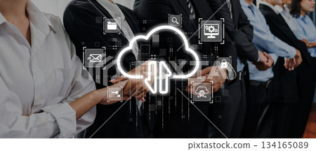 Business team collaboration in a digital workspace with cloud technology icons representing connectivity, data sharing, and teamwork in a modern office Trope 134165089