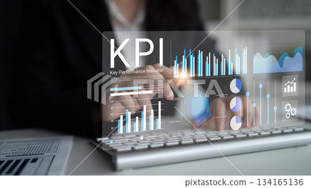 Business Professional Using Innovative Technology to Analyze Key Performance Indicators on a Laptop with Digital Graphs and Charts Displayed on Screen Gantry 134165136