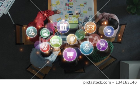 Diverse Team Collaborating on Digital Innovations with Creative Icons Representing Various Online Services and Solutions at a Modern Workspace. Raster Diverse Team Collaborating on Digital Innovations with Creative Icons Representing Various Online Services and Solutions at a Modern Workspace. Raster 134165140