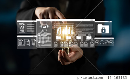 Hands holding lightbulb with digital interface showcasing artificial intelligence concepts, secure data, and innovative technology solutions in a modern setting Gantry 134165183