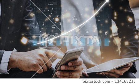 Business professional analyzing financial data on smartphone with abstract graph indicators and glowing elements in modern office environment Copula 134165235