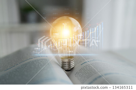 Innovative Concept of Idea Generation with Light Bulb and Financial Graph in Open Book Background for Business Growth and Creativity Scalp 134165311