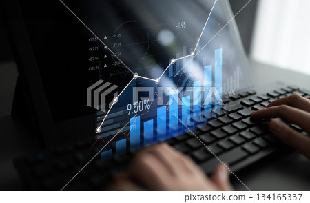 Digital graph visualization with upward trend and data analysis on a laptop screen showcasing growth, metrics, and financial indicators with hands typing on keyboard Scalp Digital graph visualization with upward trend and data analysis on a laptop screen showcasing growth, metrics, and financial indicators with hands typing on keyboard Scalp 134165337