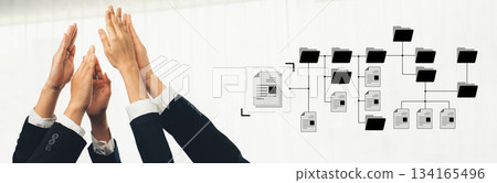 Business Team Celebrating Success with Hands Raised and Document Management Flowchart Graphical Representation on White Background Trope 134165496