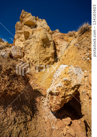 Panoramic view of red and yellow mountains with canyons and gorges at Mars Altai Russia. Popular tourist destination showcasing unique colorful geological formations. 134165603
