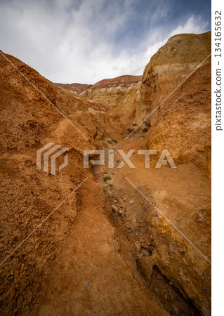 Panoramic view of red and yellow mountains with canyons and gorges at Mars Altai Russia. Popular tourist destination showcasing unique colorful geological formations. 134165632
