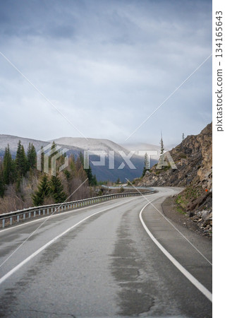 Mountain road and valley of Chuysky Trakt Altai Russia. Scenic route through rugged terrain and expansive natural landscape 134165643