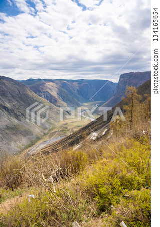Top view of mountain road leading to Katu Yaryk pass and Chulyshman valley with river in Altai Russia Dramatic highland landscape with winding route and deep canyon 134165654