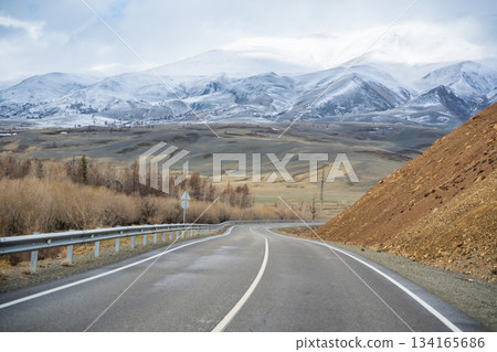Mountain road and valley of Chuysky Trakt Altai Russia. Scenic route through rugged terrain and expansive natural landscape 134165686