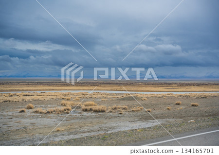 Flat valley near Kosh-Agach Altai Russia with expansive open landscape. Wide plain showcasing natural terrain and mountain surroundings Flat valley near Kosh-Agach Altai Russia with expansive open landscape. Wide plain showcasing natural terrain and mountain surroundings 134165701