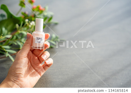 TPO free gel nail polish lying on a table in soft natural light. Highlighting clean beauty choices and awareness of Trimethylbenzoyl Diphenylphosphine Oxide in cosmetics TPO free gel nail polish lying on a table in soft natural light. Highlighting clean beauty choices and awareness of Trimethylbenzoyl Diphenylphosphine Oxide in cosmetics 134165814