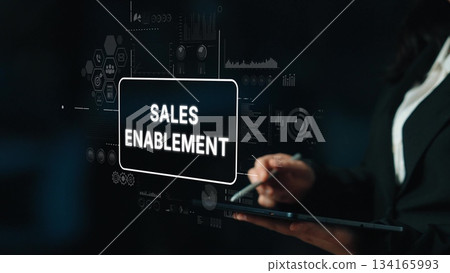 Professional Businesswoman Presenting Sales Enablement Strategy with Data Visualizations on Digital Screen. Asymptotic smart data analytic Professional Businesswoman Presenting Sales Enablement Strategy with Data Visualizations on Digital Screen. Asymptotic smart data analytic 134165993