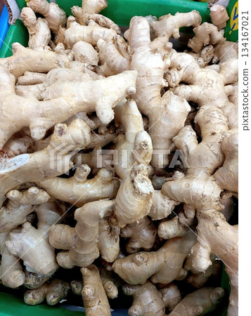Fresh Ginger Roots for Sale at Market During Afternoon Hours in the Vibrant Setting Fresh Ginger Roots for Sale at Market During Afternoon Hours in the Vibrant Setting 134167021