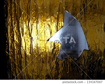 Glass From a Broken Door Reflects Light in a Dim Indoor Space During the Evening Hours Glass From a Broken Door Reflects Light in a Dim Indoor Space During the Evening Hours 134167087