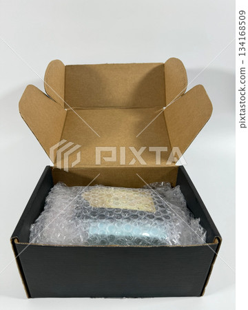 Packed Product in Open Cardboard Box 134168509