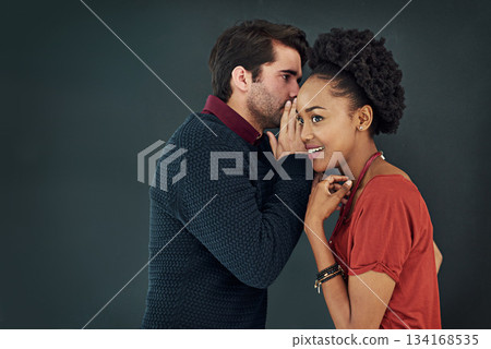 Business, man and woman with gossip, news and speaking against a dark studio background. Female person, happy male employee and staff with discussion, secret and privacy with trust, chat and story Business, man and woman with gossip, news and speaking against a dark studio background. Female person, happy male employee and staff with discussion, secret and privacy with trust, chat and story 134168535