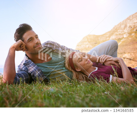Relax, smile and love with couple in nature for mountains, bonding and affectionate. Happiness, date and romance with man and woman cuddle in grass field for summer break, happy and relationship 134168585