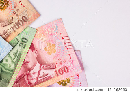 Money of various denominations arranged on a flat surface with different colors and designs visible in the background Money of various denominations arranged on a flat surface with different colors and designs visible in the background 134168660