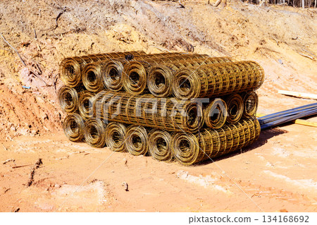 Construction site stores rolled wire mesh for upcoming building project 134168692