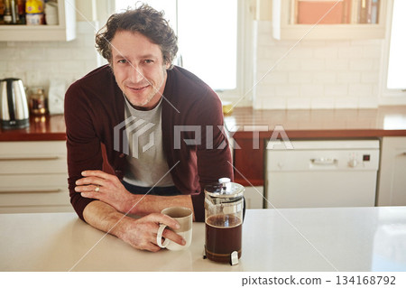 Portrait, kitchen or happy man drinking coffee for breakfast for energy to start the day at home. Smile, relax or person enjoying fresh hot tea or strong espresso with caffeine in morning routine Portrait, kitchen or happy man drinking coffee for breakfast for energy to start the day at home. Smile, relax or person enjoying fresh hot tea or strong espresso with caffeine in morning routine 134168792