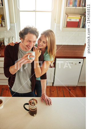 Hugging, coffee or happy couple laughing in kitchen at home bonding or enjoying quality time together. Embrace, affection or above of funny mature man relaxing or drinking tea with woman at home Hugging, coffee or happy couple laughing in kitchen at home bonding or enjoying quality time together. Embrace, affection or above of funny mature man relaxing or drinking tea with woman at home 134168811