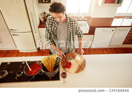 Food, cooking or above of man in kitchen with healthy vegan diet for nutrition or vegetables at home in Australia. Wine glass, spaghetti or male person in house kitchen in preparation for dinner meal 134168848