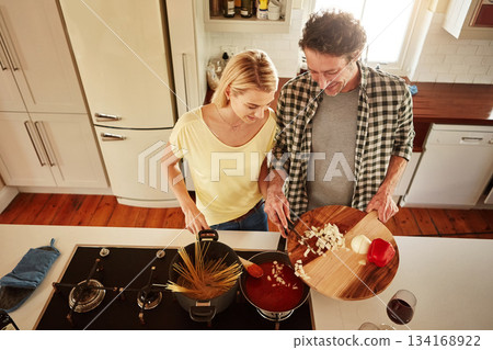Top view, food or happy couple in a kitchen cooking with healthy vegetables for dinner meal together at home. Love or woman helping or talking to mature husband in lunch diet preparation in Australia Top view, food or happy couple in a kitchen cooking with healthy vegetables for dinner meal together at home. Love or woman helping or talking to mature husband in lunch diet preparation in Australia 134168922