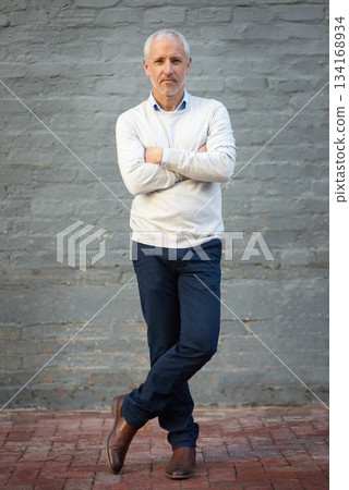 Portrait, business and mature man with arms crossed, entrepreneur and confident guy against a brick wall. Face, male person and employee with startup success, formal and professional with a career Portrait, business and mature man with arms crossed, entrepreneur and confident guy against a brick wall. Face, male person and employee with startup success, formal and professional with a career 134168934