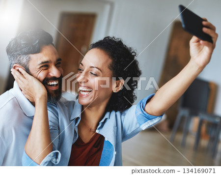 Happy couple, smile and love for selfie, profile picture or social media vlog together relaxing at home. Man and woman in relationship smiling for photo, online post or bonding memory in living room 134169071