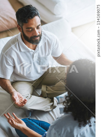 Couple, relax and meditation in living room for spiritual wellness, fitness or zen workout together at home. Man and woman relaxing in relationship, meditate or yoga class on floor for peaceful mind 134169075