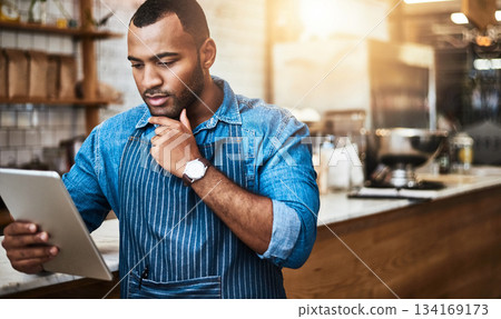 Focus, tablet and thinking with man in cafe for online, entrepreneurship and startup. Retail, technology and food industry with small business owner in restaurant for barista, store and coffee shop 134169173