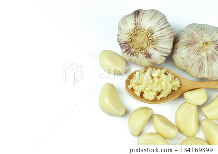 Chopped garlic in wooden spoon on a white background with copy space Chopped garlic in wooden spoon on a white background with copy space 134169399