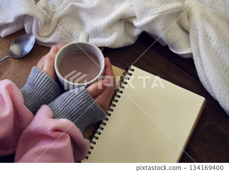 A hand holding a cup of hot chocolate 134169400