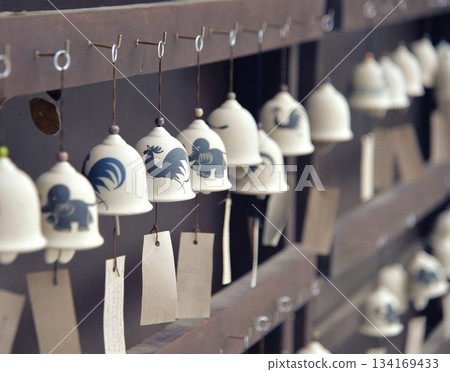 Japanese-style ceramic bells with papers for writing wishes for success 134169433