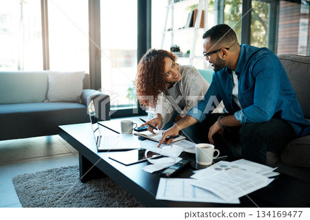 Couple with budget planning, bills and accounting of home, people with notes to pay loan and mortgage debt. Tax paperwork, man and woman happy with financial review of spending, income and savings 134169477