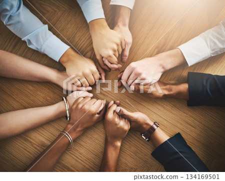 Circle, solidarity and people holding hands by table at group counseling or therapy session. Gratitude, trust and friends with intimate moment for prayer together for religion, unity and connection. 134169501