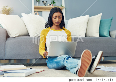Student laptop, home living room and woman reading, typing or work on research project, university report or studying. Serious focus, lounge floor and female person learning, education and search web 134169513