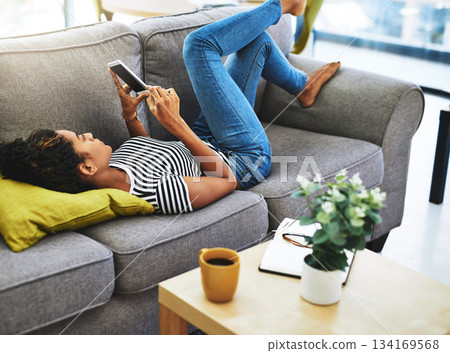 Relax, smartphone and woman on sofa in home for network, online website and social media. Communication, mobile app and calm female person on phone for chatting, text message and internet connection Relax, smartphone and woman on sofa in home for network, online website and social media. Communication, mobile app and calm female person on phone for chatting, text message and internet connection 134169568