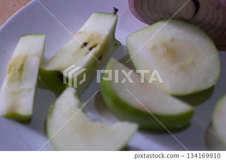 Cutted apples on a white plate 134169910