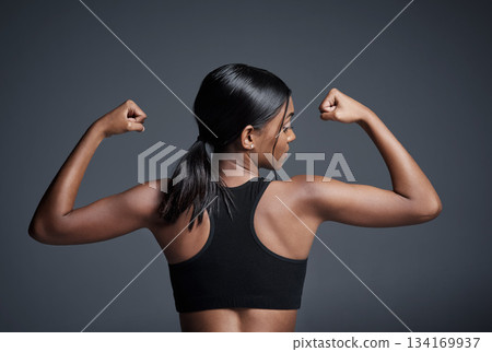 Sports, workout and woman flexing back in studio isolated on a black background. Strong flex, muscle and female athlete with bicep, arm strength or bodybuilder training, fitness and healthy exercise. Sports, workout and woman flexing back in studio isolated on a black background. Strong flex, muscle and female athlete with bicep, arm strength or bodybuilder training, fitness and healthy exercise. 134169937