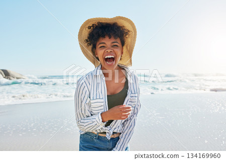 Woman, laughing and portrait in summer at beach for a vacation, travel or holiday with a smile. Face of African female person at sea with happiness, freedom and funny mindset outdoor with a blue sky 134169960