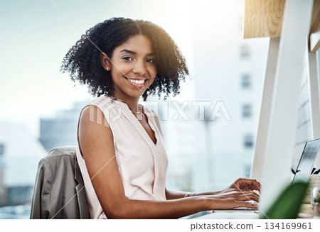 Typing, computer and portrait of woman in office planning, online management and productivity for business mindset. Face of a happy professional worker, employee or African person working on desktop 134169961